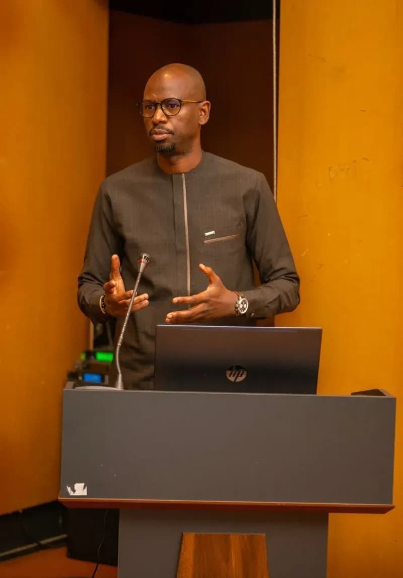 A Sensoft speaker presents from the lectern, laptop open